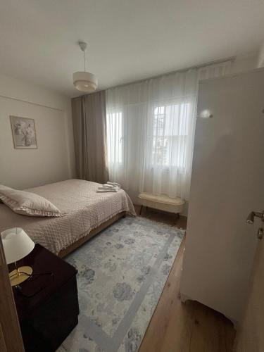 a small bedroom with a bed and a window at Urla Garden House in Urla