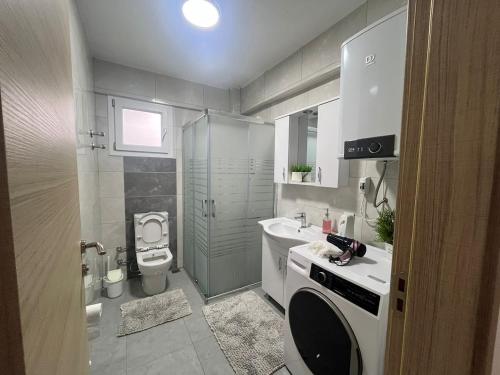 a small bathroom with a toilet and a sink at Urla Garden House in Urla