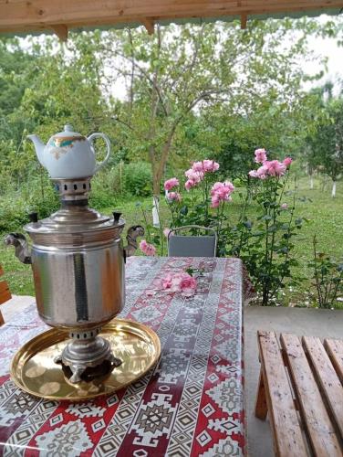 a table with a tea pot on top of it at Shahdag Beloved Home in Qusar