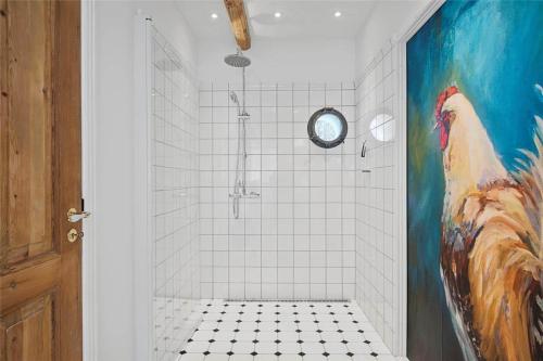 a bathroom with a shower with a painting of a chicken at FA028-Karise-Tagerupvej-29 in Karise