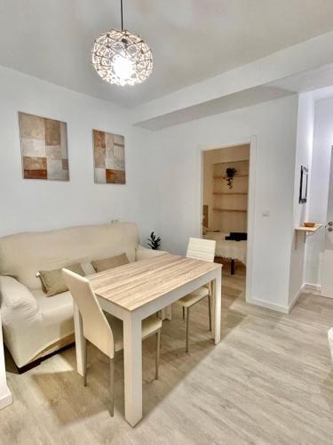 a living room with a table and a couch at San Roque 7 in Archidona