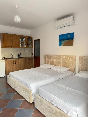 two beds sitting next to each other in a bedroom at N'Gjaci Guest House in Tale