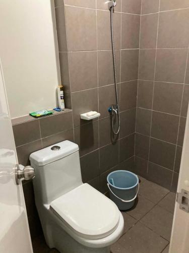 a small bathroom with a toilet and a shower at Linear Space at Soleia Butuan Unit G in Butuan