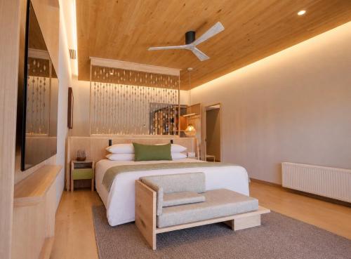 a bedroom with a bed and a ceiling fan at Nayara Alto Atacama in San Pedro de Atacama