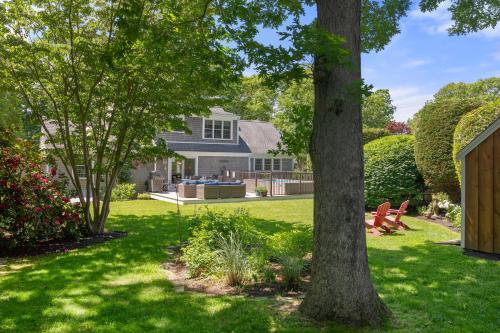 a yard with two trees and a house at Heated Plunge Pool Theater Room Backyard Fun in Orleans
