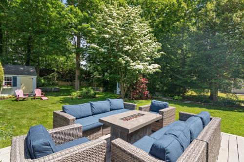 a patio with a blue couch and a table at Heated Plunge Pool Theater Room Backyard Fun in Orleans