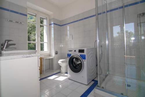 a bathroom with a washing machine in a shower at Villa Supina - 3BDR with Pool & Panoramic Lake Garda Views in Toscolano Maderno