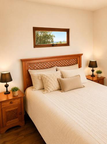 a bedroom with a bed with two lamps and a mirror at Del sol 2 in La Boca