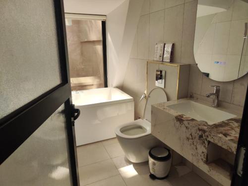 a bathroom with a white toilet and a sink at كوخ ساره سبيشل دورين in Al-ʿUla