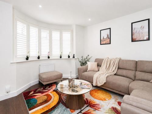 a living room with a couch and a table at Open Mind Property - Ensuite Room Number 3 in Fareham