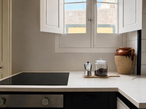 a kitchen with white cabinets and a black counter top at Palazzo Vite in Copertino