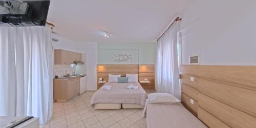 a bedroom with a bed with towels on it at Filomeni Studios in Pefkochori