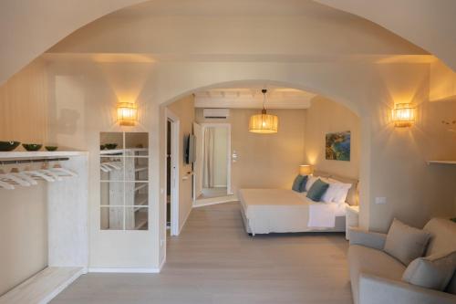 a bedroom with a bed and a couch in a room at King Rooms in Portoferraio