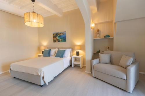 a bedroom with a bed and a chair in it at King Rooms in Portoferraio