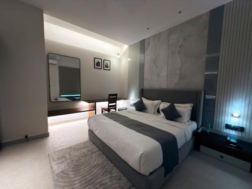 a bedroom with a large bed and a large mirror at Radiance Hotel in Sirsa