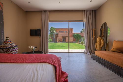 a bedroom with a bed and a view of a building at PALAIS SOHAN in Marrakesh