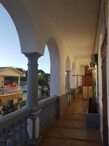 a balcony of a building with a view of a courtyard at Le Valiha Hotel in Antsiranana