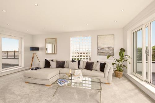 a living room with a couch and a table at Beadnell Point - North East Escapes in Beadnell
