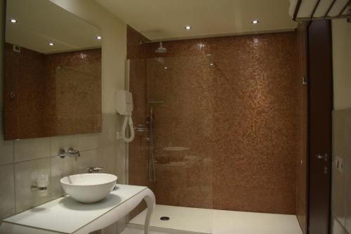 a bathroom with a sink and a glass shower at Residenza Wagner in Palermo