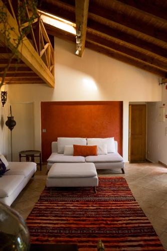 a large room with two beds and a rug at Monte D´Sancho in Aljezur