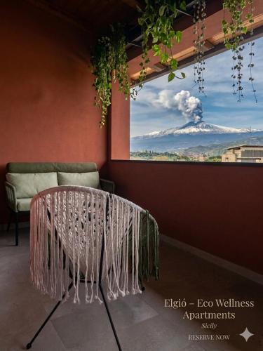 a table in a room with a view of a mountain at Elgio' Design Retreat with Etna View Taormina in Taormina