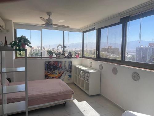 a bedroom with a bed and a view of the city at 123Eilat panorama in Eilat