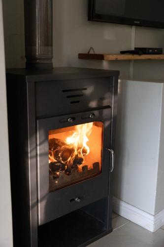 a black stove with a fire inside of it at Le Vaal Manor in Parys