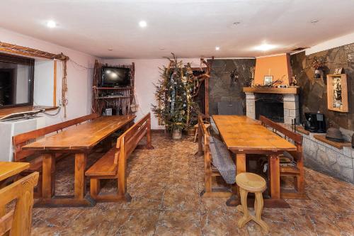 a dining room with wooden tables and a christmas tree at Vatra Hotel in Yaremche