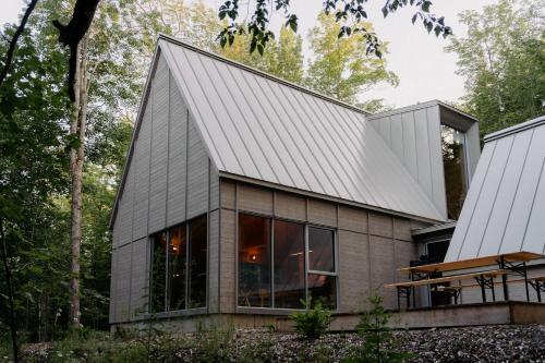 a house in the woods with a metal roof at The Cape in Rawdon