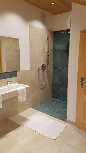 a bathroom with a shower and a sink at Landhaus Hickman in Hopferau