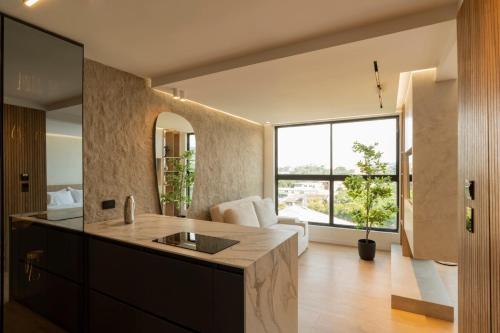 a large kitchen with a large window and a living room at Modern, Fully Equipped and Cozy Loft in Cali
