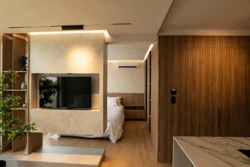 a bedroom with a bed and a television in a room at Modern, Fully Equipped and Cozy Loft in Cali
