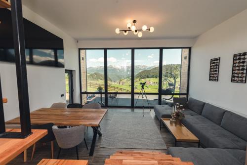 a living room with a couch and a table at Serra Chalet in Fundata