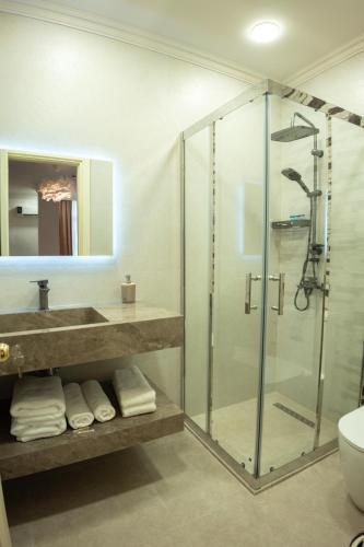 a bathroom with a glass shower and a sink at Gala Terrace Hotel & Restaurant in Baku