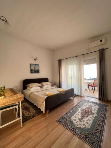 a bedroom with a large bed and a table at Suka Apartments in Ulcinj