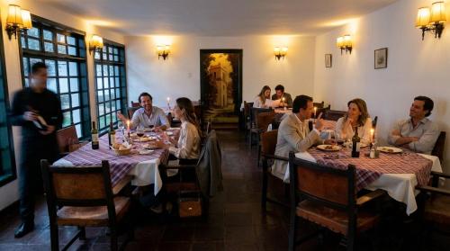 a group of people sitting at tables in a restaurant at Hacienda Suescún - 300 Años de Historia in Tibasosa