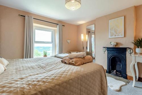 a bedroom with a large bed with a fireplace at 3 Bed in Lydbrook oc-94490 in Lydbrook