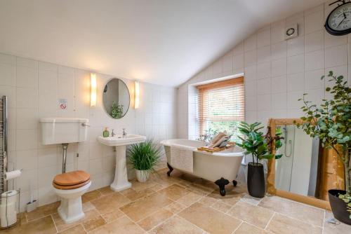 a bathroom with a tub and a toilet and a sink at 3 Bed in Lydbrook oc-94490 in Lydbrook