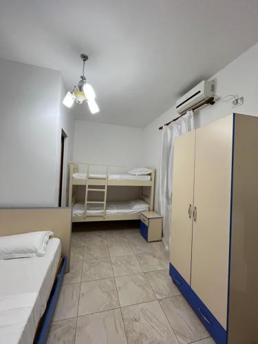 a dorm room with two beds and a cabinet at Zefigrillhouse in Tale