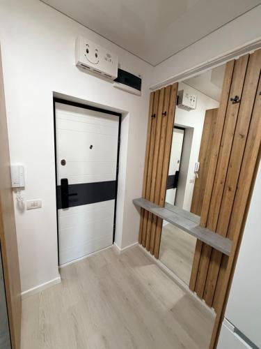 a hallway with a door and a mirror at La Ion Residence 1 in Năvodari