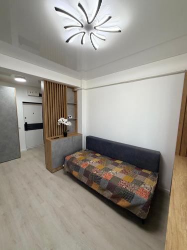 a bedroom with a bed and a chandelier at La Ion Residence 1 in Năvodari