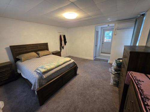 a bedroom with a bed and a window and a door at A J House in Plano