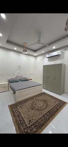 a bedroom with a bed and a rug on the floor at Ras Al Hadd's bounty in Sur