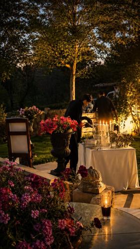 a couple of people standing at a table with flowers at Laklouk 1808 Lodge by Hansa in ‘Ayn aş Şalīb