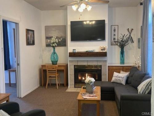 a living room with a couch and a fireplace at The Cottage on the Coast in Oceano