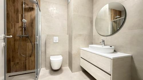 a bathroom with a toilet and a sink and a mirror at Salt Oasis Apartment Tuzla in Tuzla