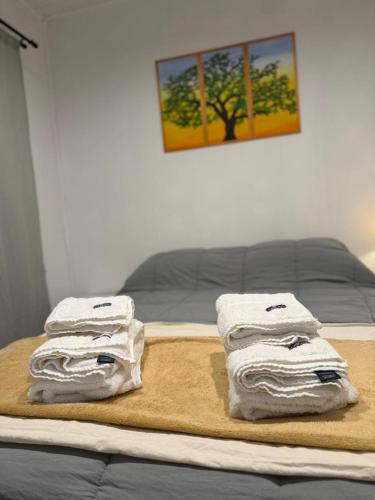 a pile of towels sitting on top of a bed at Complejo San Carlos in General Acha