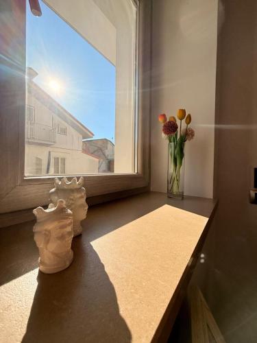 a vase of flowers sitting on a window sill at Perla Marina B&B in Nicotera Marina