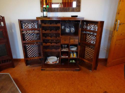a wine cabinet filled with lots of wine bottles at Gästehaus zum Felsen in Überlingen