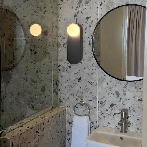 a bathroom with a sink and a mirror at Thatch Haven in Mahikeng